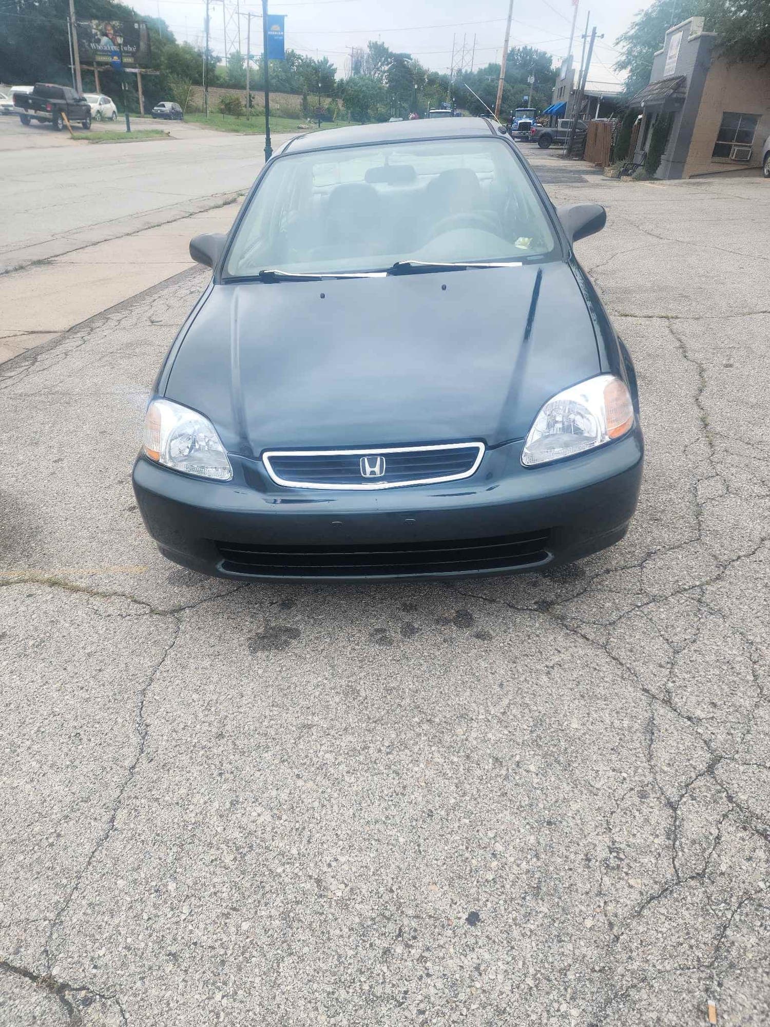 Honda Civic, front end: after repair. The same Honda Civic after repair, with a straight hood and new headlight